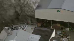 SkyTeam 11 is over a fire at a Waste Management warehouse containing scrap metal on Wicomico and Bayard streets, near the stadiums, in Baltimore.