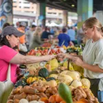 A customer pays for produce at a farmers market in Baltimore,MD: A customer pays for produce at a farmers market in Baltimore,MD. (Photo by: Edwin Remsberg / VWPics/Universal Images Group via Getty Images)