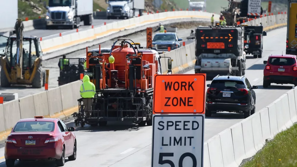 Greenwich Township, PA - April 27: Cars and trucks go past a crew painting a line on interstate 78 with a "Work Zone" and "Speed Limit 50" sign in the foreground. During a press conference held by PennDOT next to Interstate 78 in Greenwich township Tuesday morning April 27, 2021 where they highlighted the need for safety around work zones on roads. (Photo by Ben Hasty/MediaNews Group/Reading Eagle via Getty Images)