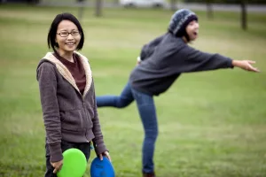 Leslie Chung (left) and Anna Obikane play frisbee golf at the Druid Hill Park disc golf course in Baltimore, Maryland on October 6, 2009.