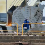 IMG_2634: A worker at the Sparrows Point salvage site uses metal cutting equipment to disassemble a chunk of the bridge removed from the crash site.  (Image Credit: Phil Yacuboski
Anchor/Reporter
WBAL-AM 1090 and FM 101.5