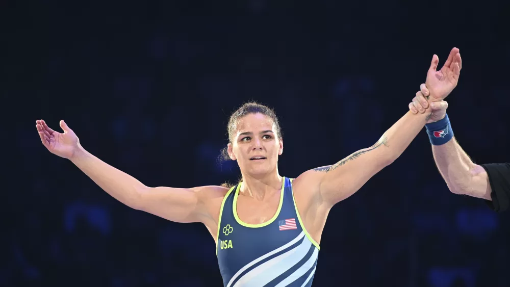 Kayla Miracle raises her arms after winning a 62-kilogram bout in the finals at the U.S. Olympic wrestling trials in State College, Pa., Saturday, April 20, 2024. (AP Photo/Aidan Conrad)