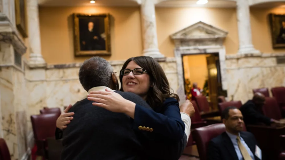 ANNAPOLIS, MD - DECEMBER 6: Sen. Sarah Elfreth, right, is the youngest woman to ever serve in the Maryland state Senate. She gives a hug to Joy Walker, the Office administrator for Senater Thomas V. Miller Jr., the president of the Maryland Senate during an orientation in the Senate Chamber. There is a large number of women who are joining the Maryland General Assembly. The freshman class has one of its largest groups of women. (photo by Sarah L. Voisin/The Washington Post via Getty Images) Maryland state lawmaker defeats Jan. 6 police officer in Democratic House primary