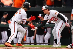 BALTIMORE, MD - APRIL 17: Gunnar Henderson #2 of the Baltimore Orioles celebrates with Adley Rutschman #35 after hitting a home run against the Minnesota Twins during the first inning at Oriole Park at Camden Yards on April 17, 2024 in Baltimore, Maryland. (Photo by Scott Taetsch/Getty Images)