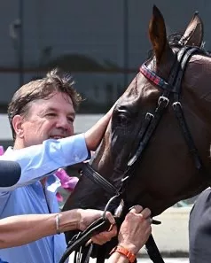 Trainer Graham Motion in the winner's circle with Trikari after the 2024 Belmont Derby