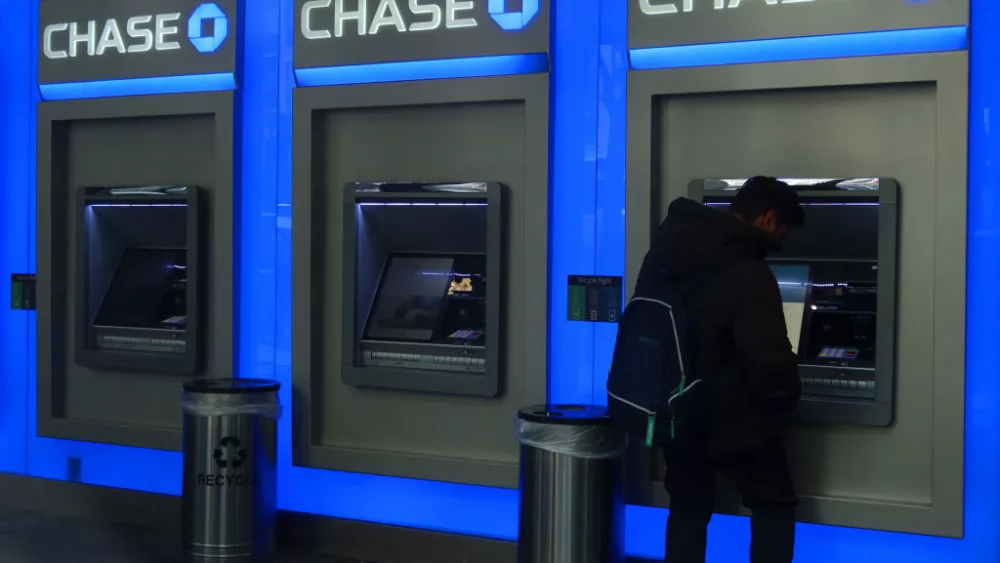NEW YORK, NY - FEBRUARY 29: A person uses a Chase bank ATM on February 29, 2024, in New York City. (Photo by Gary Hershorn/Getty Images)