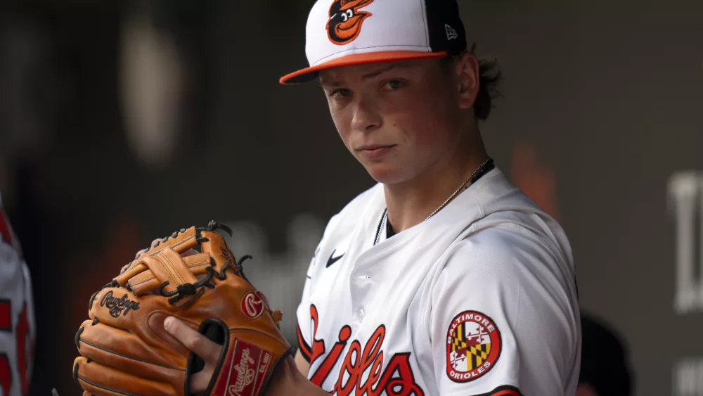 Baltimore Orioles second baseman Jackson Holliday (7) gets ready in the dugout before a baseball game against the Toronto Blue Jays, Wednesday, July 31, 2024, in Baltimore. (AP Photo/Stephanie Scarbrough)