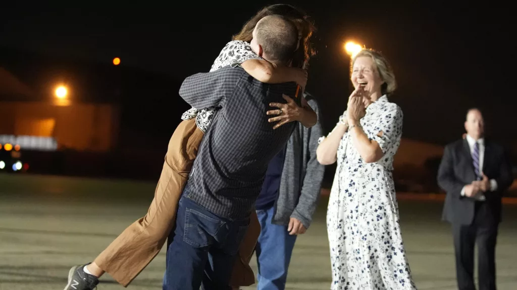 Reporter Evan Gershkovich hugs his mother Ella Milman, left, at Andrews Air Force Base, Md., following his release as part of a 24-person prisoner swap between Russia and the United States