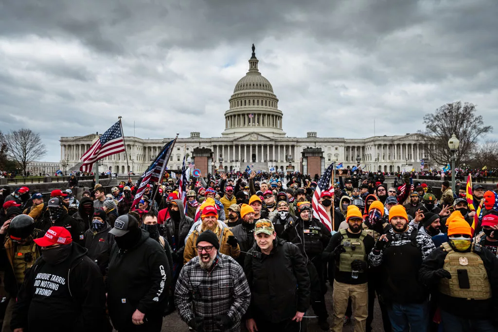 WASHINGTON, DC - JANUARY 06: Pro-Trump protesters, including Proud Boys leader Joe Biggs, (plaid shirt at bottom center of frame,) gather in front of the U.S. Capitol Building on January 6, 2021 in Washington, DC. A pro-Trump mob stormed the Capitol, breaking windows and clashing with police officers. Trump supporters gathered in the nation's capital today to protest the ratification of President-elect Joe Biden's Electoral College victory over President Trump in the 2020 election. (Photo by Jon Cherry/Getty Images)