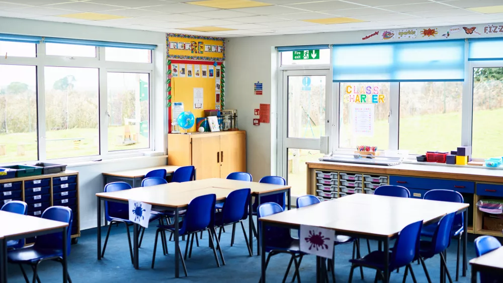 Tidy tables and chairs arranged in school class room, ready for pupils to arrive, education, learning, organisation