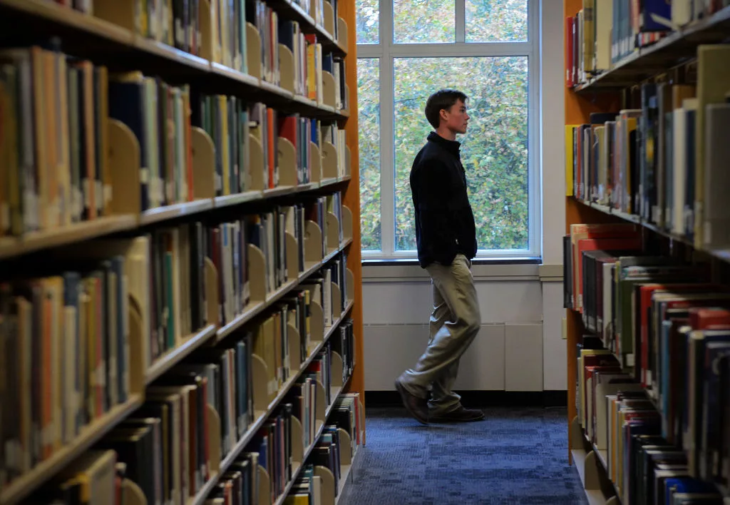 ST. MARY'S, MD - NOVEMBER 1: High school senior Mike Dorsch, of Howard county, walks through the library while on a tour of St. Mary's college with prospective enrollment in the balance on November, 01, 2013 in St. Mary's, MD. (Photo by Bill O'Leary/The Washington Post via Getty Images)