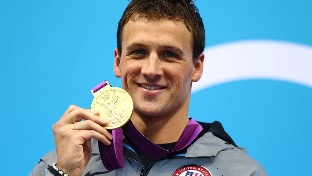 LONDON, ENGLAND - JULY 28: Ryan Lochte of the United States celebrates with his Gold Medal during the Medal Ceremony for the Men's 400m Individual Medley on Day 1 of the London 2012 Olympic Games at the Aquatics Centre on July 28, 2012 in London, England. (Photo by Al Bello/Getty Images)