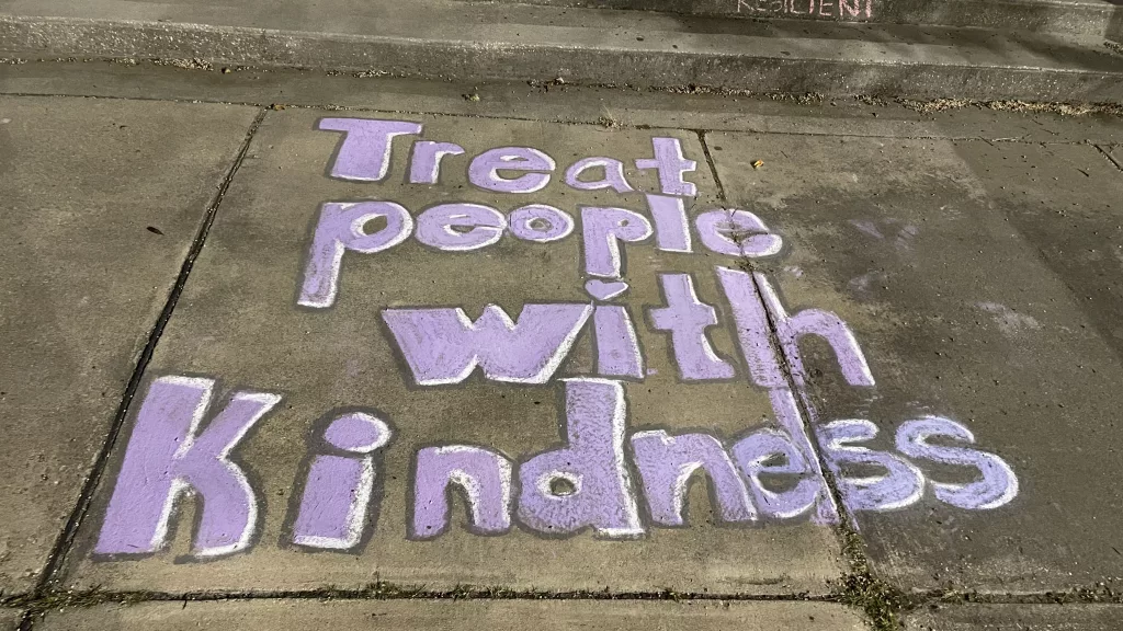 Chalk messages for students from the community and makeshift memorials at Joppatowne High School.