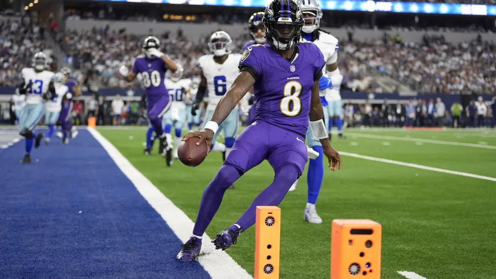 Baltimore Ravens quarterback Lamar Jackson (8) runs the ball for a touchdown against the Dallas Cowboys in the first half of an NFL football game in Arlington, Texas, Sunday, Sept. 22, 2024. (AP Photo/Julio Cortez)