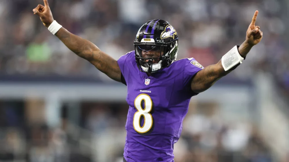 ARLINGTON, TEXAS - SEPTEMBER 22: Quarterback Lamar Jackson #8 of the Baltimore Ravens celebrates throwing a touchdown pass against the Dallas Cowboys during the second quarter at AT&T Stadium on September 22, 2024 in Arlington, Texas. (Photo by Ron Jenkins/Getty Images)