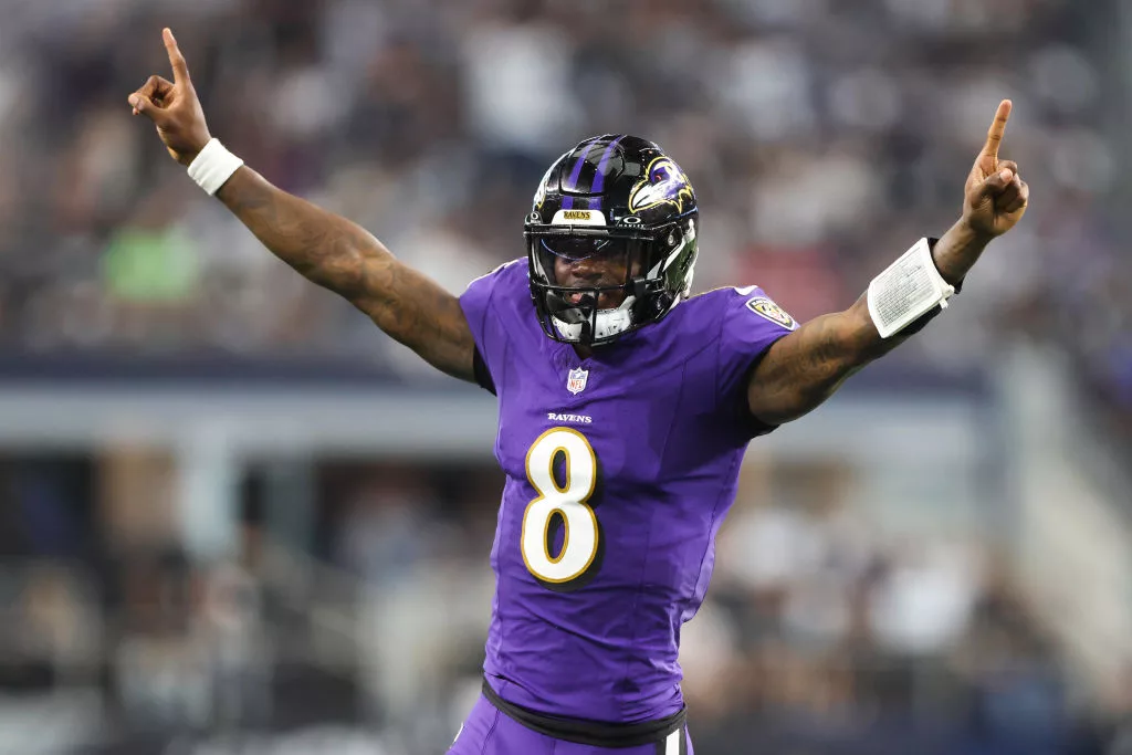 ARLINGTON, TEXAS - SEPTEMBER 22: Quarterback Lamar Jackson #8 of the Baltimore Ravens celebrates throwing a touchdown pass against the Dallas Cowboys during the second quarter at AT&T Stadium on September 22, 2024 in Arlington, Texas. (Photo by Ron Jenkins/Getty Images)