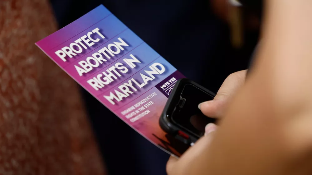 COLLEGE PARK, MARYLAND - JUNE 24: An audience member holds a brochure on abortion rights as Vice President Kamala Harris delivers remarks on reproductive rights at Ritchie Coliseum on the campus of the University of Maryland on June 24, 2024 in College Park, Maryland. Harris is speaking on the two year anniversary of the Dobbs decision, the Supreme Court ruling that overturned Roe v. Wade and struck down federal abortion protections. (Photo by Kevin Dietsch/Getty Images)