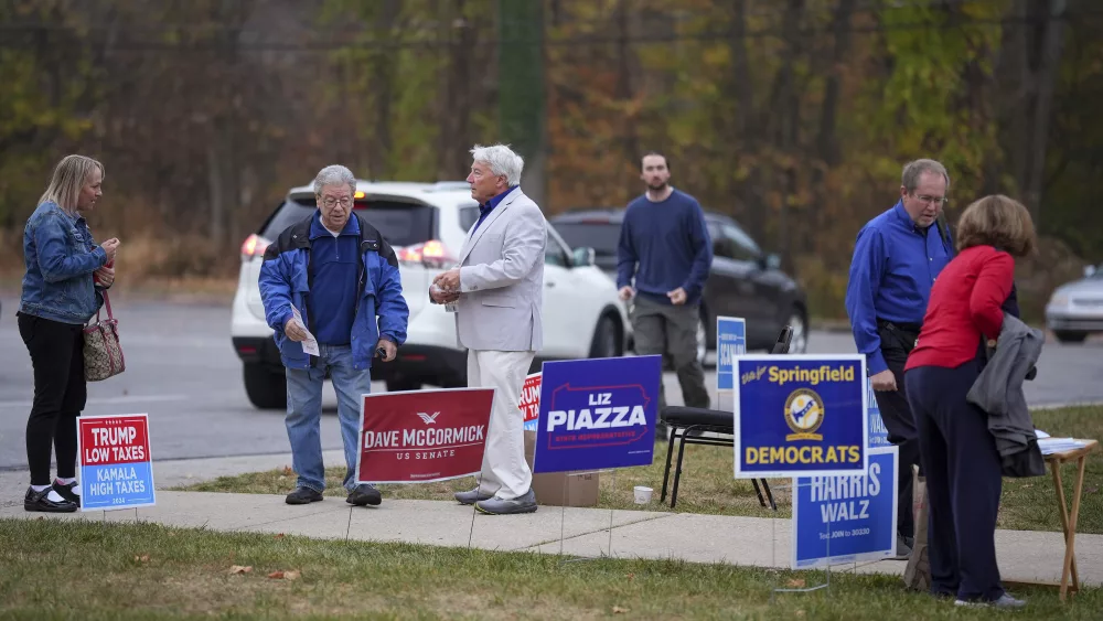 People arrive at polling place to vote, Tuesday, Nov. 5, 2024, in Springfield, Pa. (AP Photo/Matt Slocum)