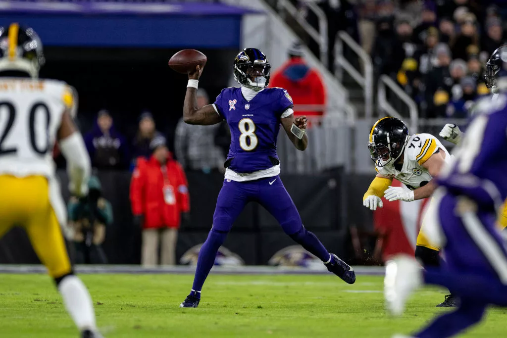 BALTIMORE, MARYLAND - DECEMBER 21: Lamar Jackson #8 of the Baltimore Ravens looks to pass on the run during an NFL Football game against the Pittsburgh Steelers at M&T Bank Stadium on December 21, 2024 in Baltimore, Maryland. (Photo by Michael Owens/Getty Images)