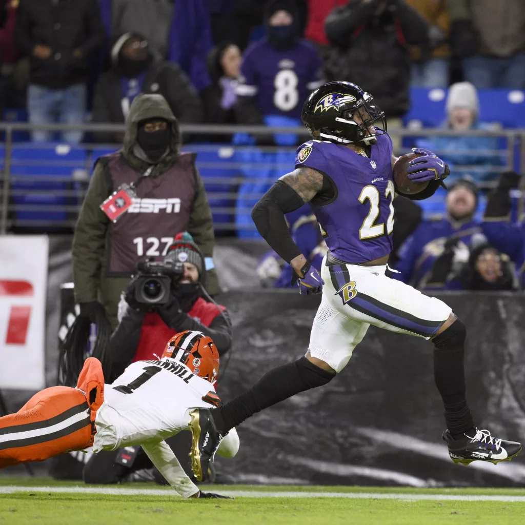 Baltimore Ravens running back Derrick Henry, right, scores past Cleveland Browns safety Juan Thornhill (1) on a 43-yard touchdown run during the second half of an NFL football game Saturday, Jan. 4, 2025, in Baltimore. (AP Photo/Nick Wass)