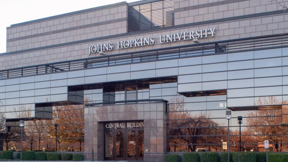 Slightly angled view of Gilchrist Hall, with autumnal trees reflected in the mirrored facade, at the Johns Hopkins University's Montgomery County Campus, Maryland, November 16, 2004. From the Homewood Photography Collection. (Photo by JHU Sheridan Libraries/Gado/Getty Images)