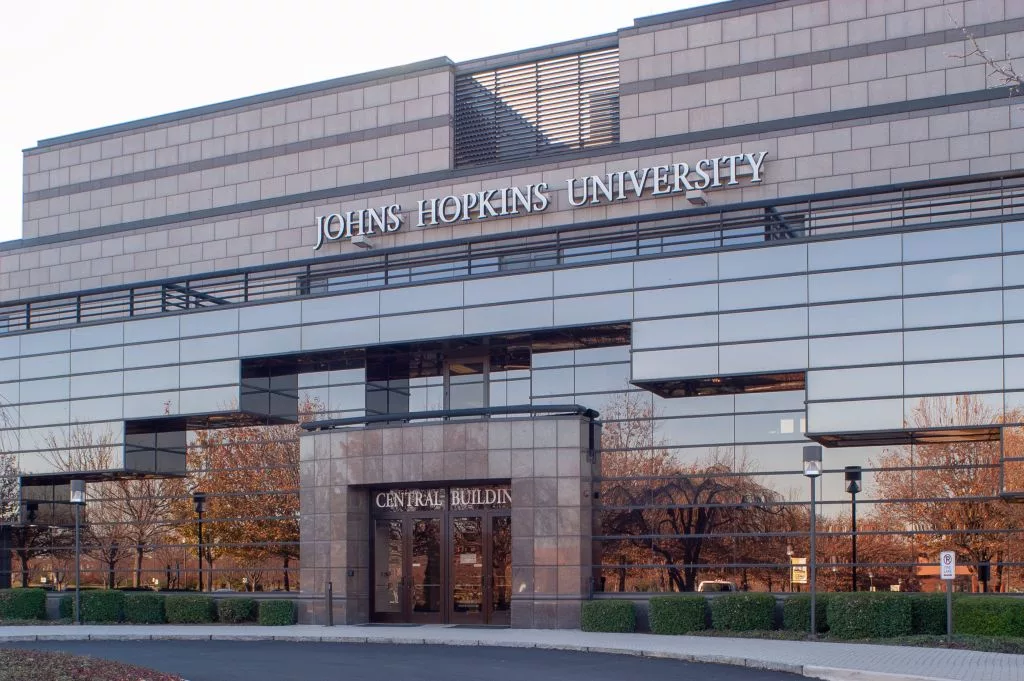 Slightly angled view of Gilchrist Hall, with autumnal trees reflected in the mirrored facade, at the Johns Hopkins University's Montgomery County Campus, Maryland, November 16, 2004. From the Homewood Photography Collection. (Photo by JHU Sheridan Libraries/Gado/Getty Images)