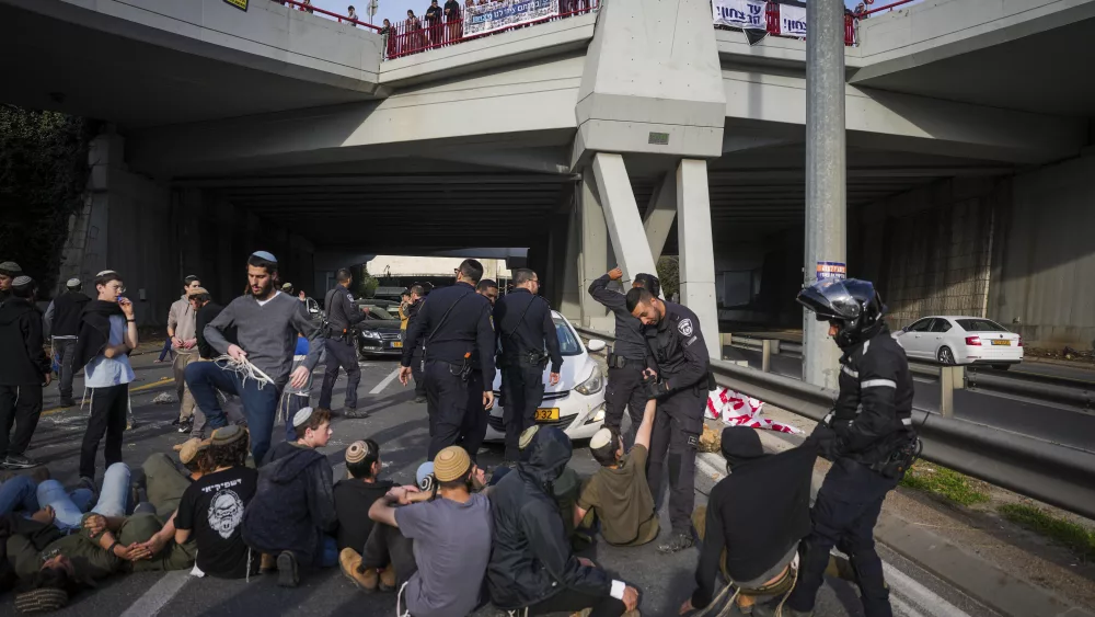 Police disperse demonstrators who are blocking a road during a protest against the ceasefire deal between Israel and Hamas in Jerusalem on Thursday, Jan. 16, 2025. (AP Photo/Ohad Zwigenberg)