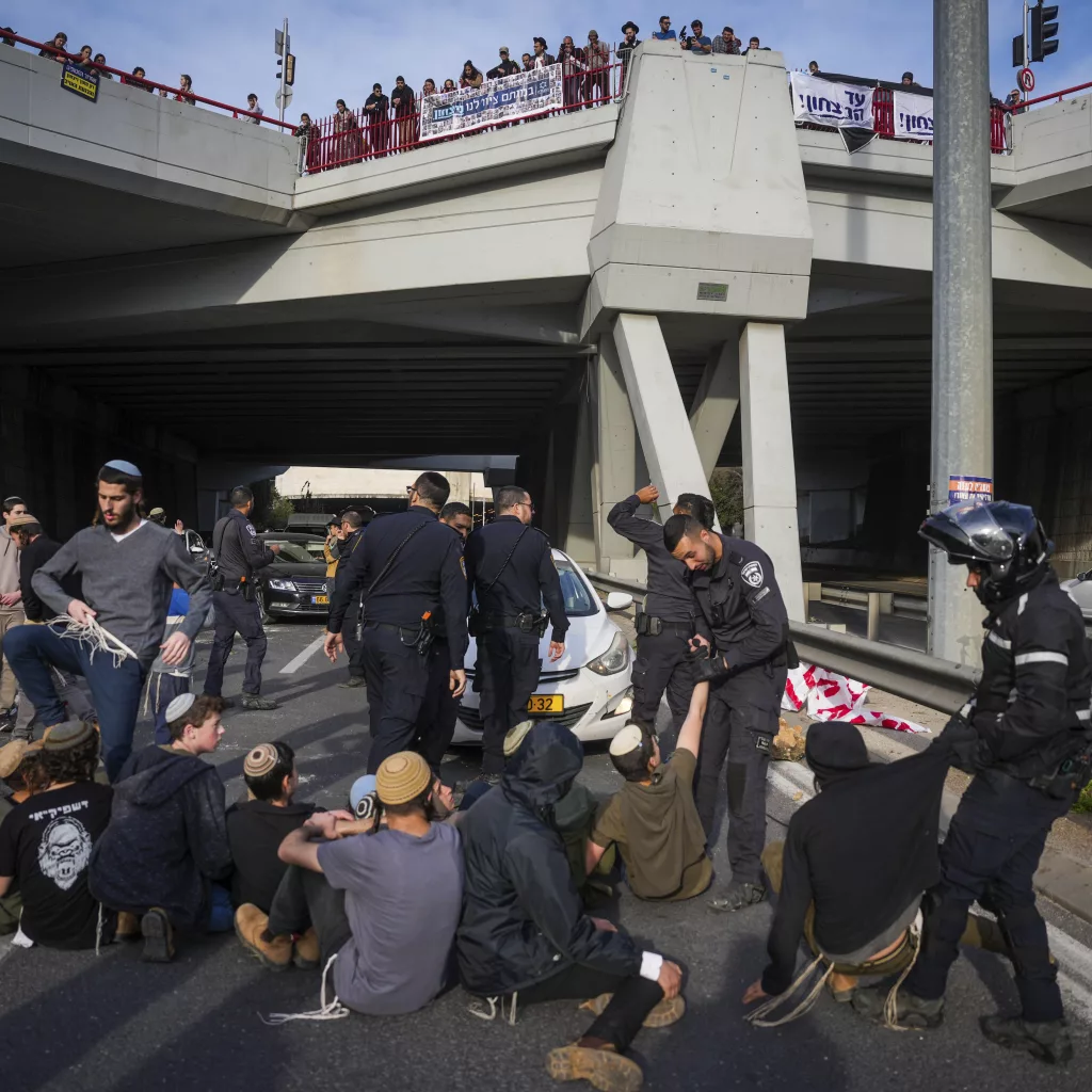 Police disperse demonstrators who are blocking a road during a protest against the ceasefire deal between Israel and Hamas in Jerusalem on Thursday, Jan. 16, 2025. (AP Photo/Ohad Zwigenberg)