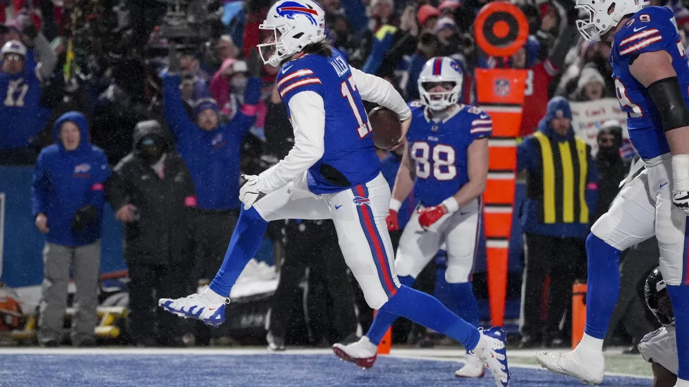 Buffalo Bills quarterback Josh Allen (17) carries the ball into the end zone to score a touchdown against the Baltimore Ravens during the second quarter of an NFL divisional playoff football game, Sunday, Jan. 19, 2025, in Orchard Park, N.Y. (AP Photo/Gene J. Puskar)