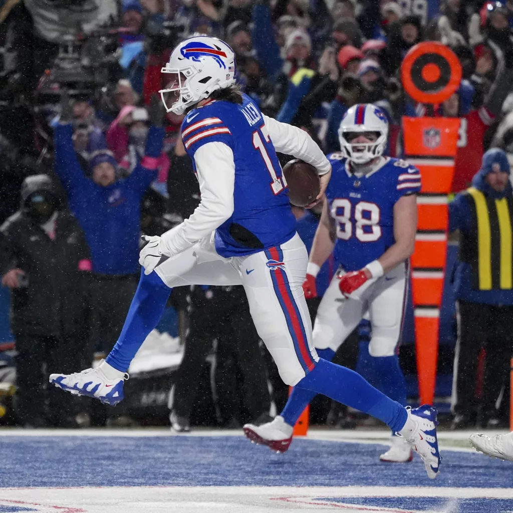 Buffalo Bills quarterback Josh Allen (17) carries the ball into the end zone to score a touchdown against the Baltimore Ravens during the second quarter of an NFL divisional playoff football game, Sunday, Jan. 19, 2025, in Orchard Park, N.Y. (AP Photo/Gene J. Puskar)