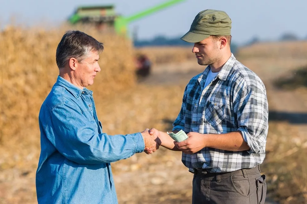 Happy farmer after harvest of corn