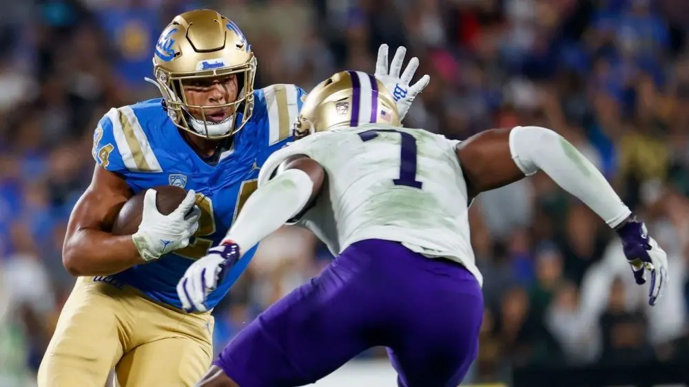 UCLA moving backmost Zach Charbonnet (24) escapes a tackle-attempt by Washington linebacker Dominique Hampton (7) during an NCAA assemblage shot crippled Friday^ Sept. 30^ 2022^ successful Pasadena^ Calif.