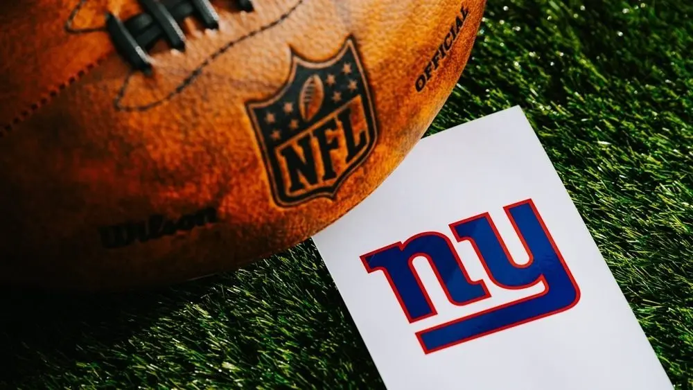 New York Giants NFL squad Logo and American shot shot connected Green Grass. NEW YORK^ USA^ FEBRUARY 10^ 2025