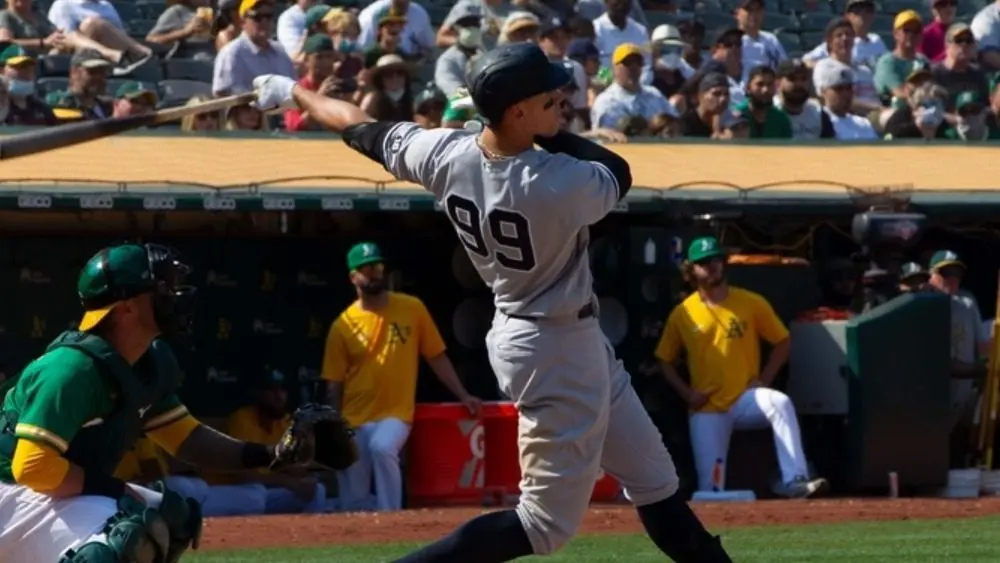 Aaron Judge #99 of the New York Yankees hits a 9th inning location tally against the Oakland Athletics astatine Ring Central Coliseum. Oakland^ California - August 28^ 2021