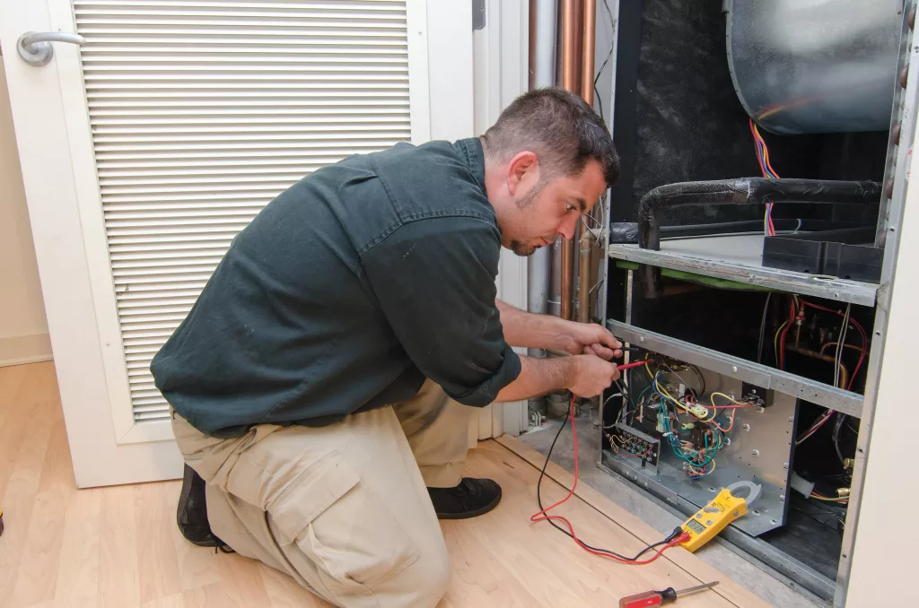 hvactechnicianworkingonaresidentialheatpump