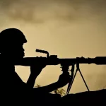 a-ugandan-soldier-of-341-battalion-serving-with-the-african-union-mission-in-somalia-amisom-holds-a-rocket-propelled-grenade-at-sunrise-30-april-2012-on-the-frontline-near-the-main-road-on-the-nort