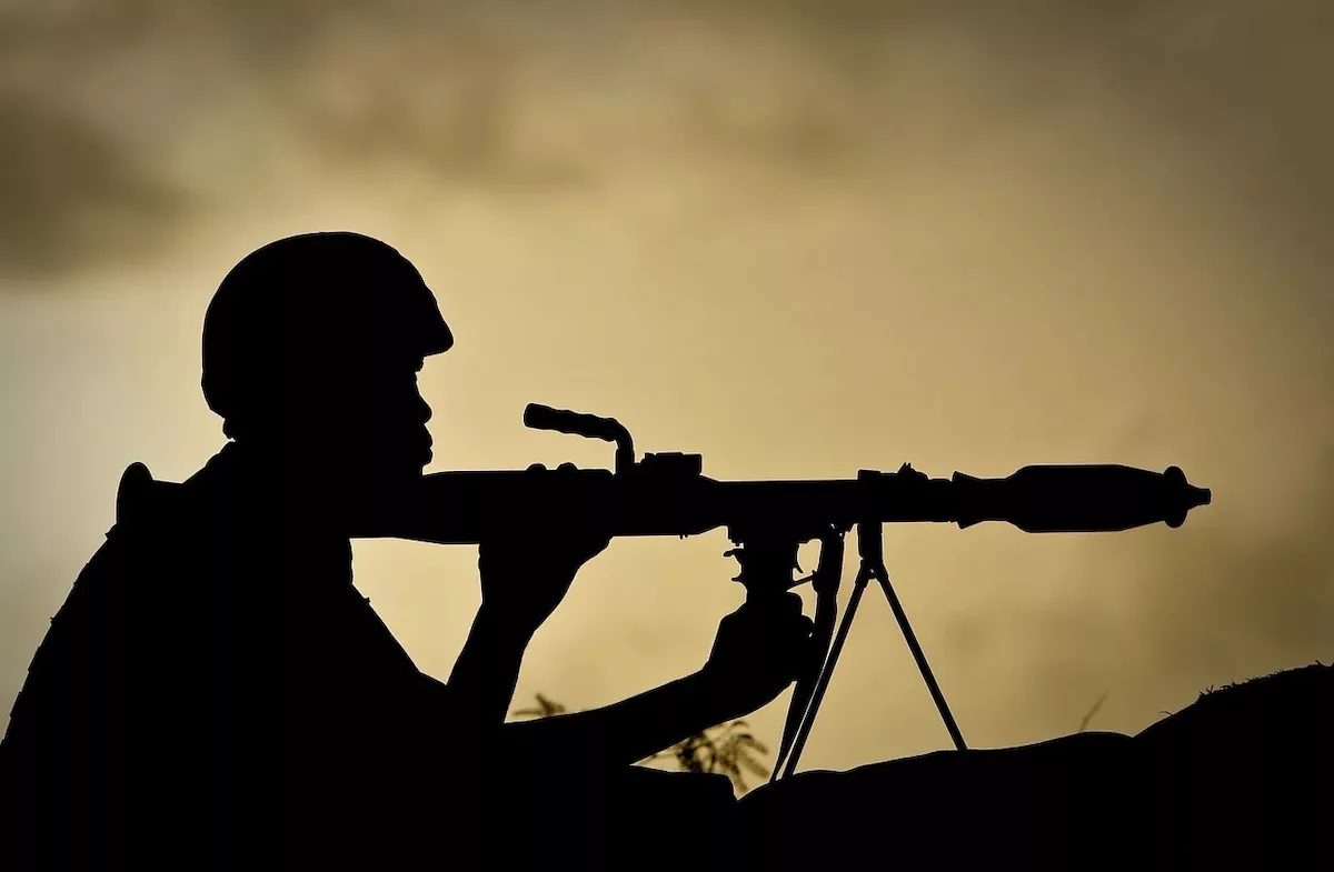 a-ugandan-soldier-of-341-battalion-serving-with-the-african-union-mission-in-somalia-amisom-holds-a-rocket-propelled-grenade-at-sunrise-30-april-2012-on-the-frontline-near-the-main-road-on-the-nort