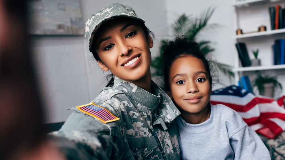 smiling-african-american-daughter-and-soldier-in-military-uniform-taking-selfie-at-home