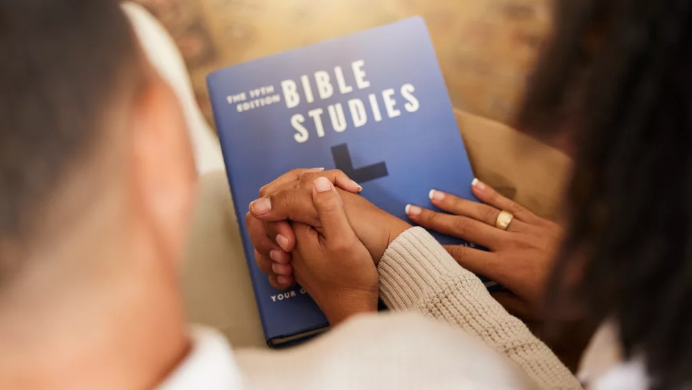 religion-studying-and-couple-holding-hands-with-a-2023-11-27-05-21-34-utc