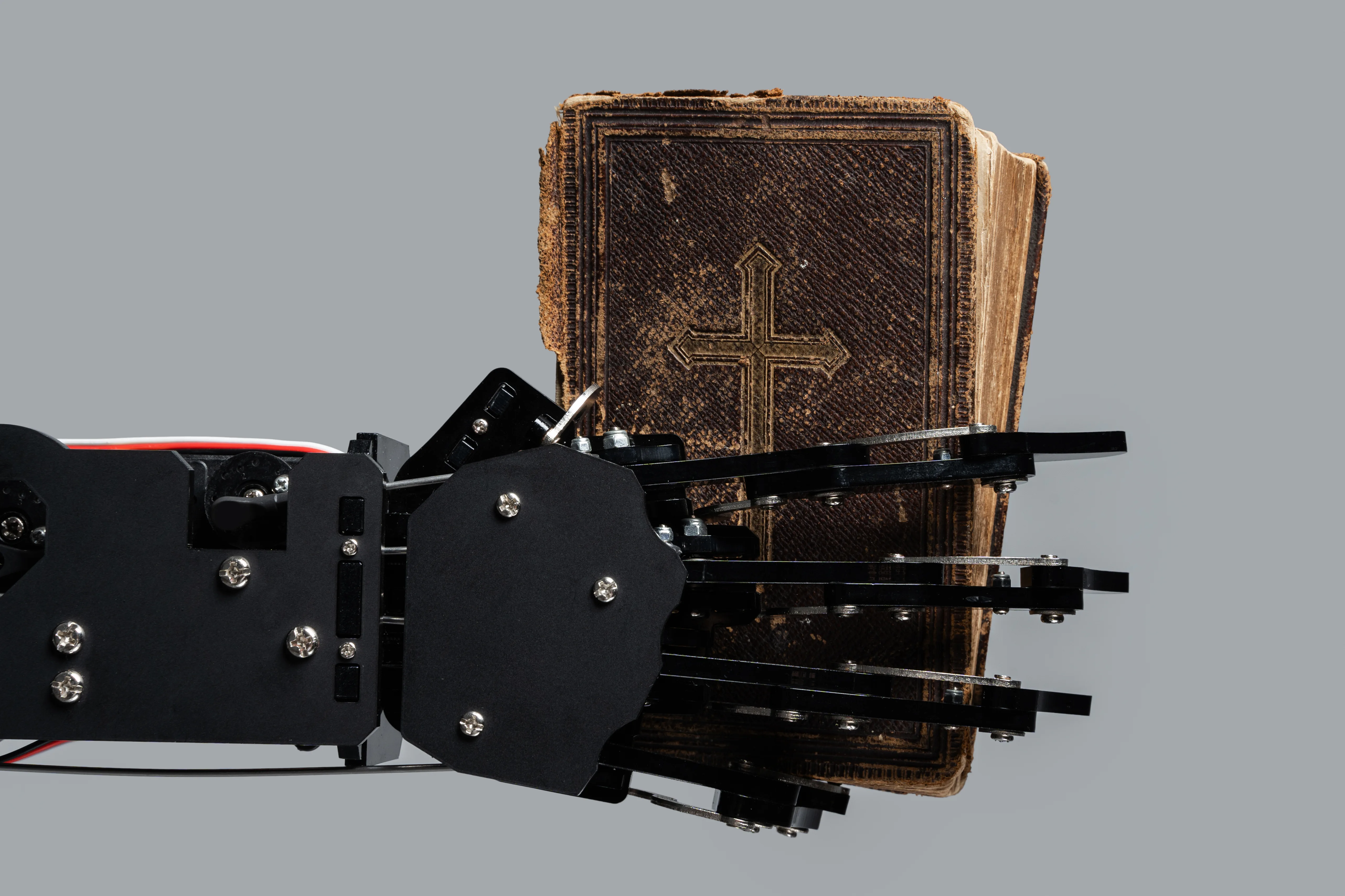 real-robots-hand-with-ancient-bible-concepts-of-artificial-int