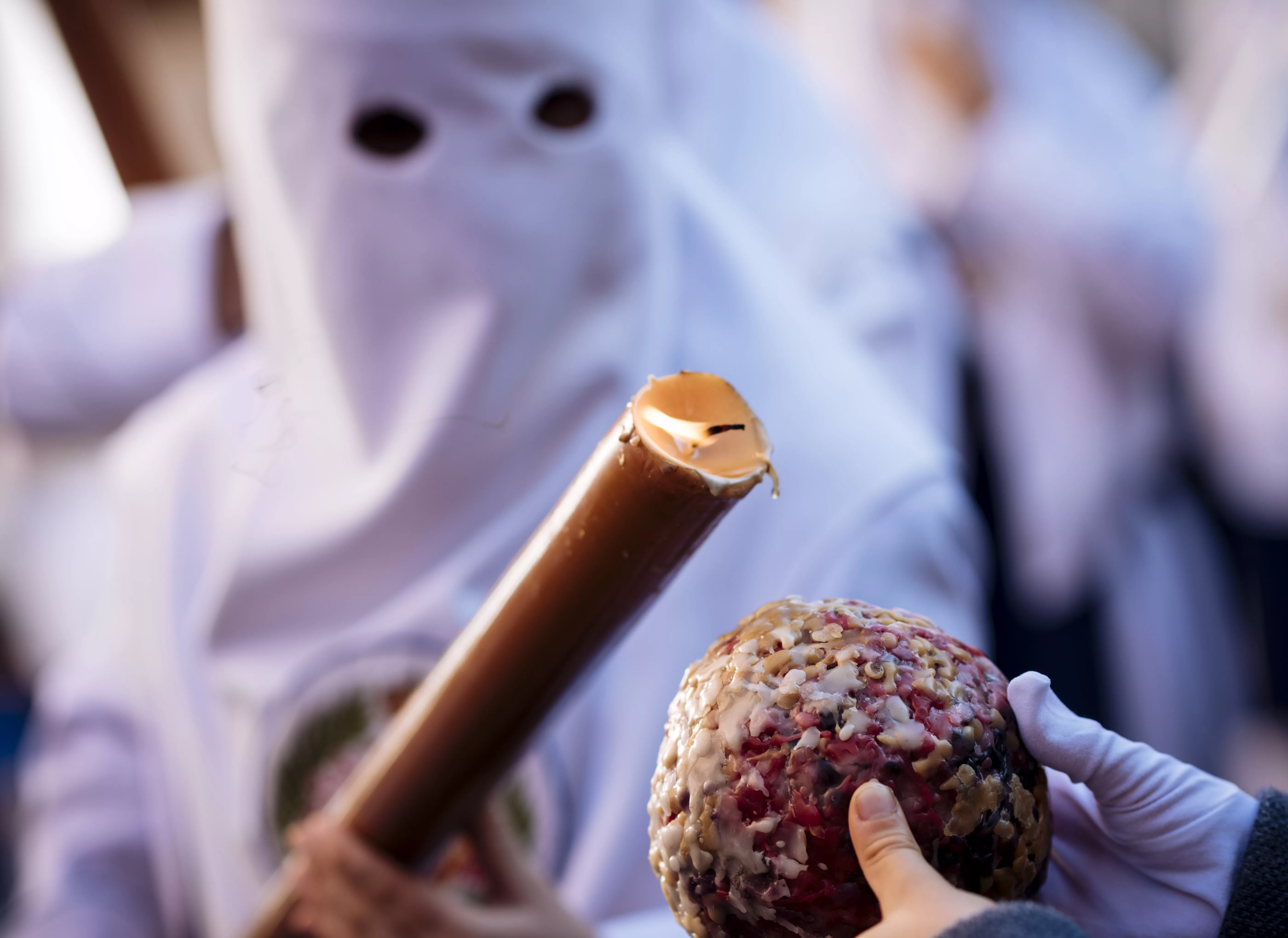 person-in-white-traditional-mask-holding-a-decorative-scepter-at-a-cultural-event