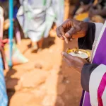 close-up-of-the-hands-of-an-african-priest-who-is-about-to-give-the-sacramental-bread-to-believers