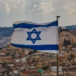 close-up-shot-of-the-flag-of-israel-with-the-old-city-in-background-2