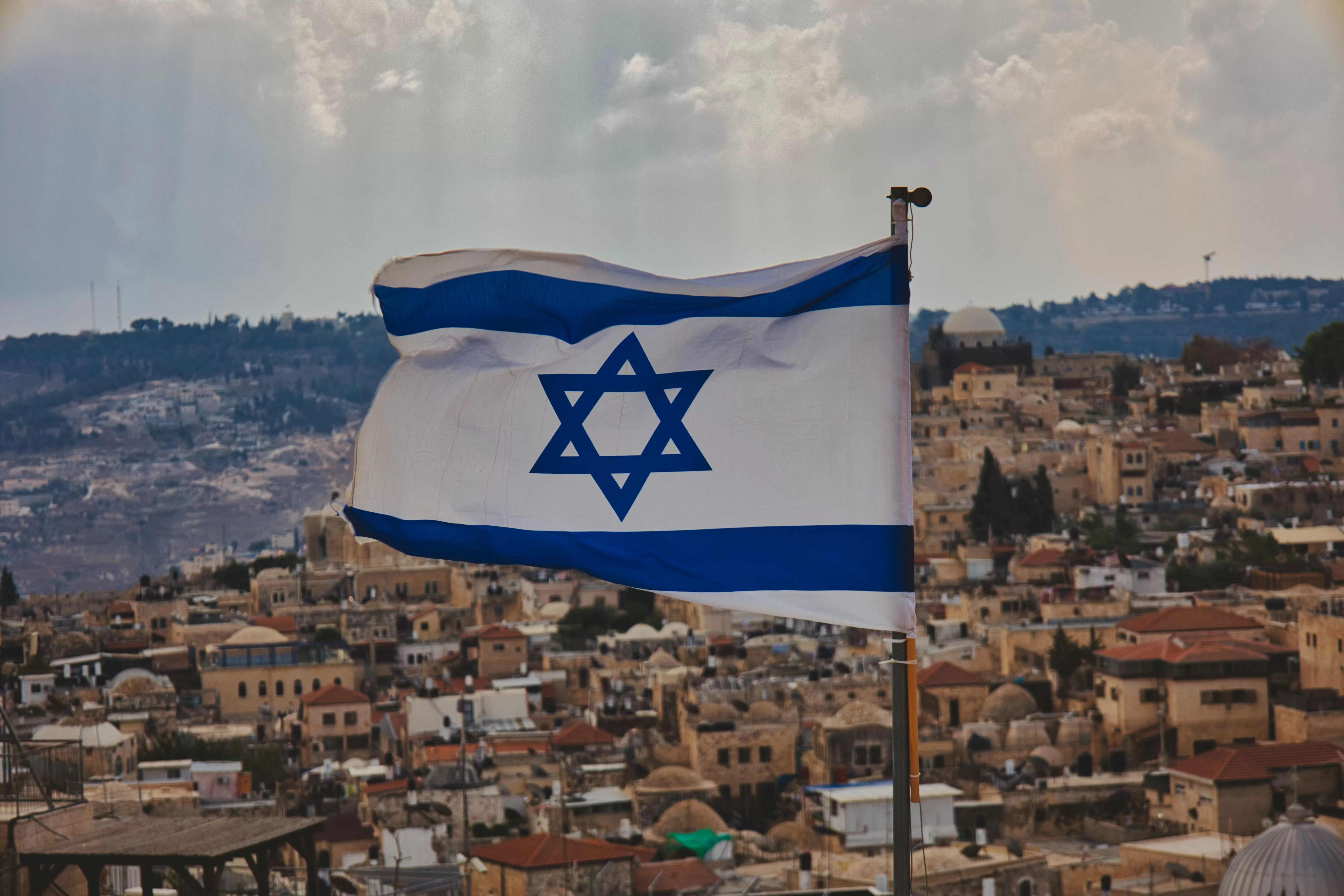 close-up-shot-of-the-flag-of-israel-with-the-old-city-in-background-2