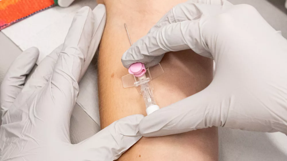 closeup-top-view-shot-of-medical-personnel-inserting-an-intravenous-infusion-needle