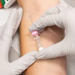closeup-top-view-shot-of-medical-personnel-inserting-an-intravenous-infusion-needle