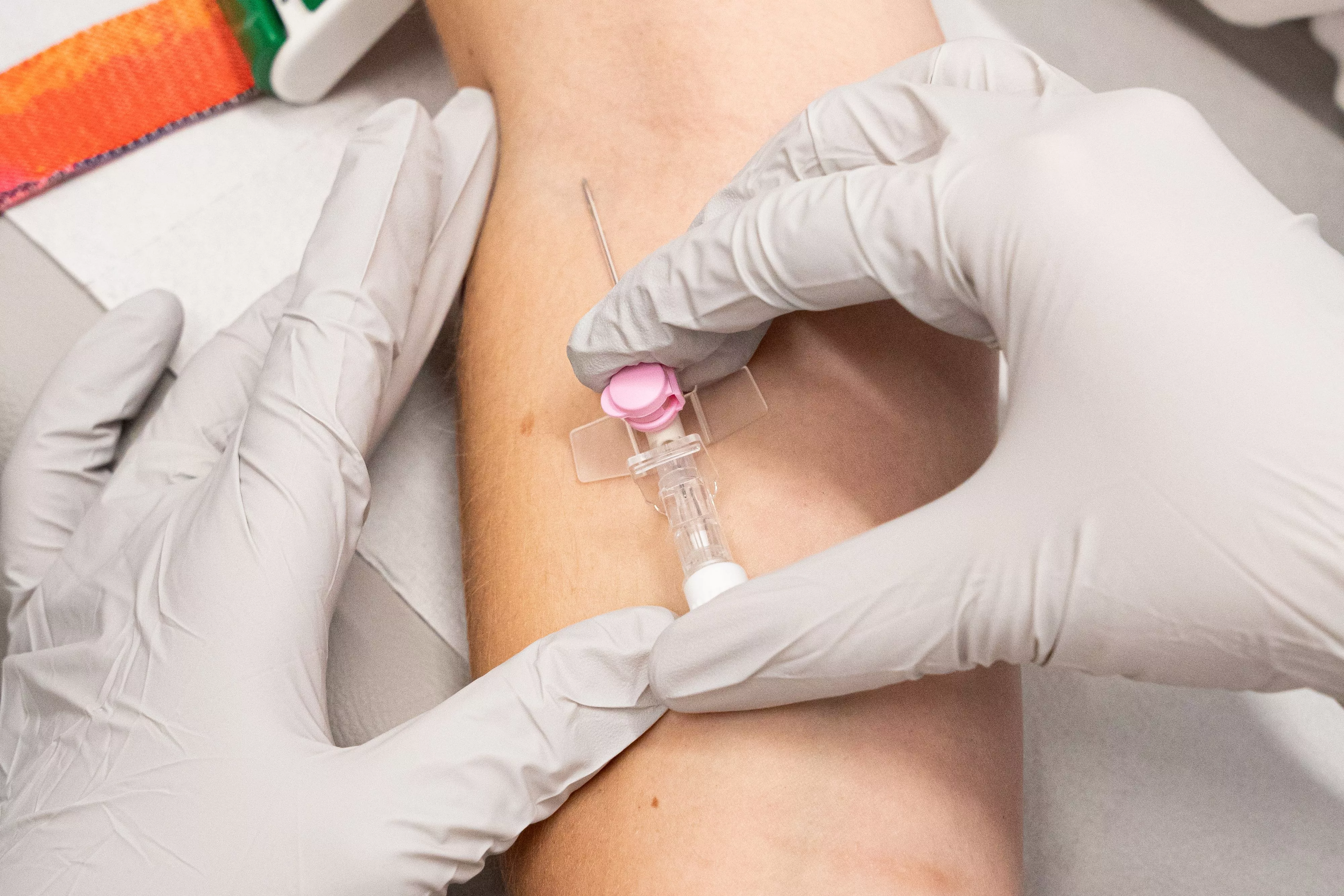 closeup-top-view-shot-of-medical-personnel-inserting-an-intravenous-infusion-needle