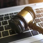selective-focus-image-of-judge-gavel-and-keyboard-2023-11-27-05-01-24-utc