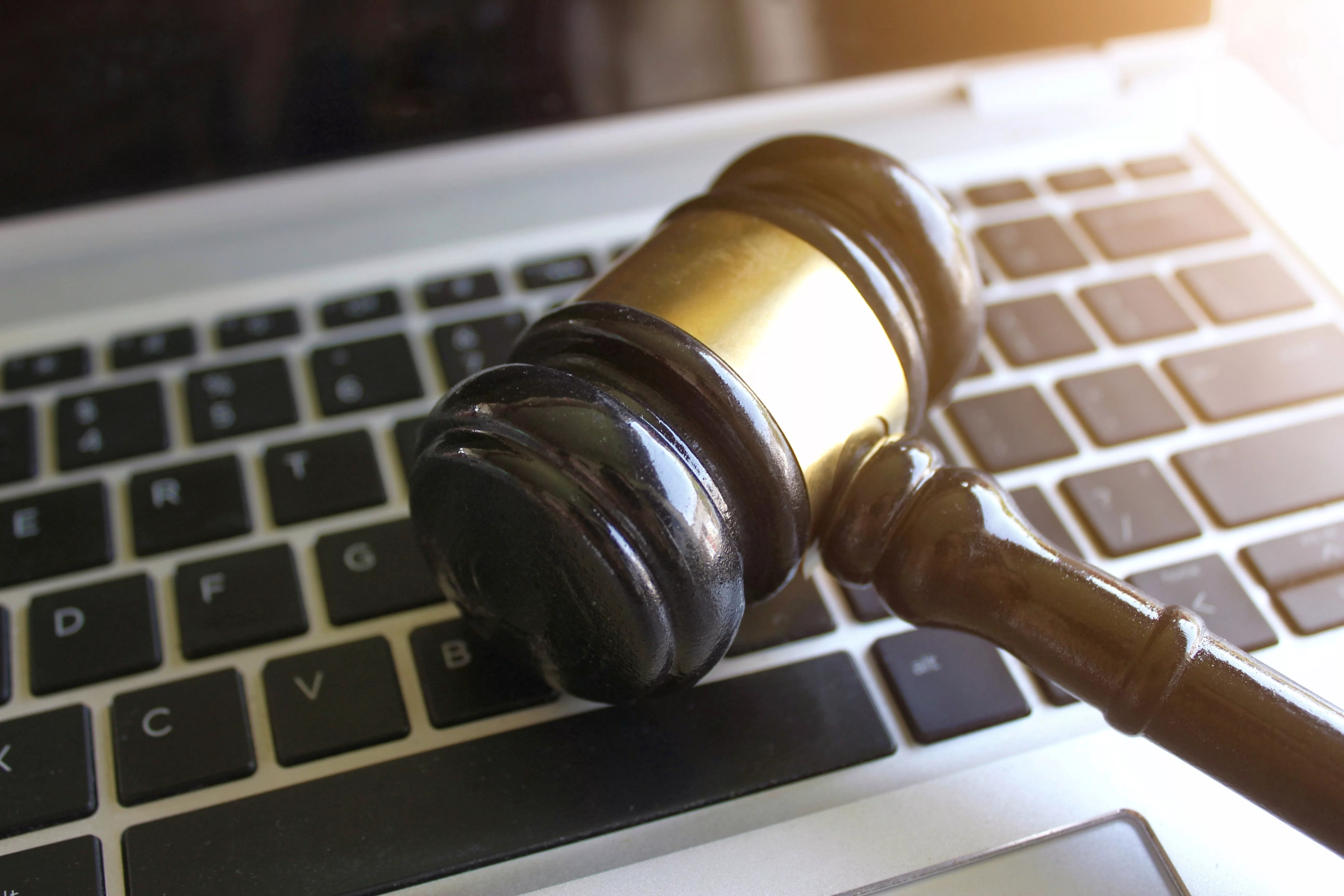 selective-focus-image-of-judge-gavel-and-keyboard-2023-11-27-05-01-24-utc