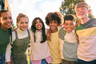 portrait-showing-class-of-secondary-or-high-school-pupils-standing-outside-school-building-hugging